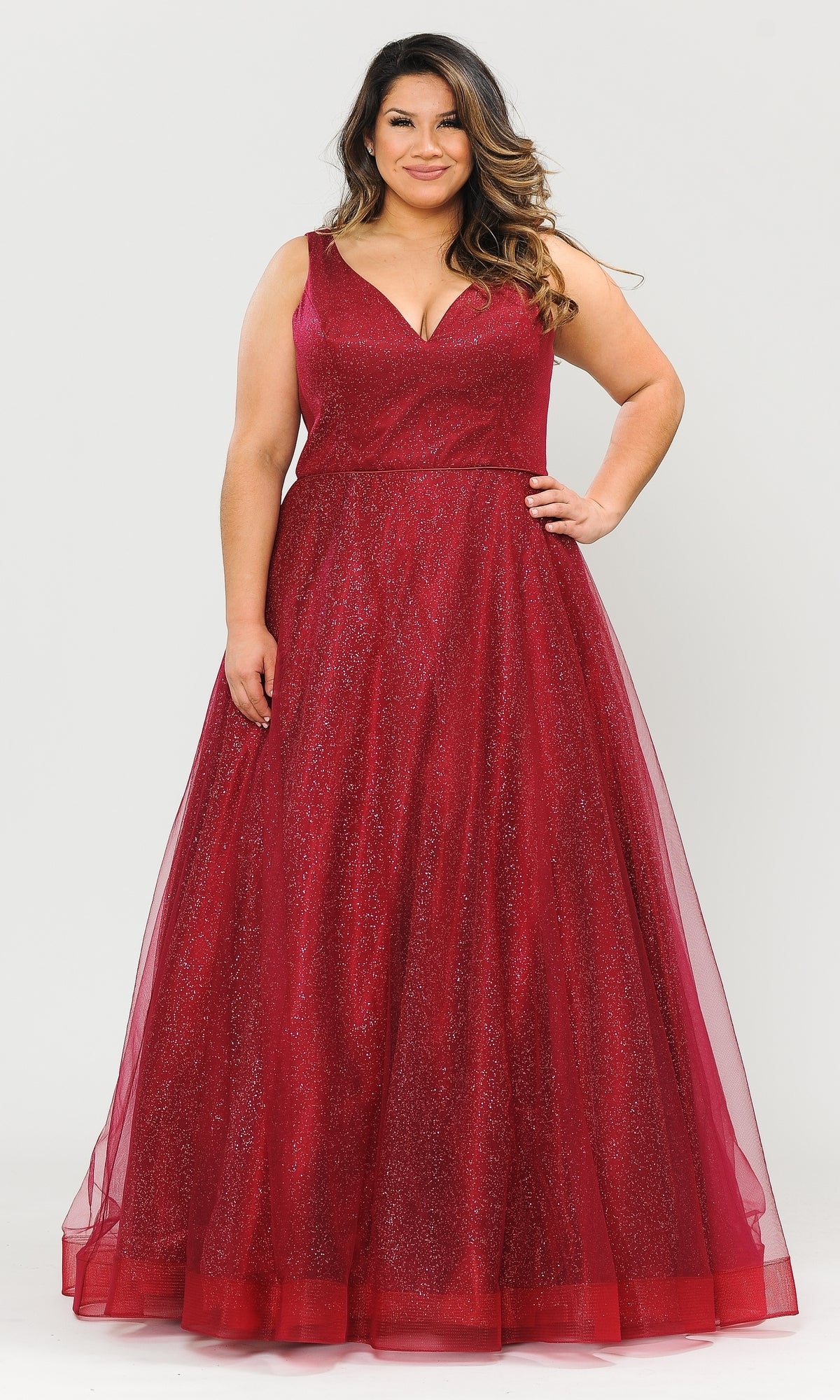 A woman smiles with one hand on her hip, modeling the Glitter-Tulle Plus-Size Long Prom Gown W1024 in sparkling red against a plain white background.